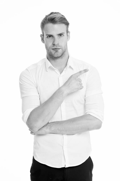Pointing direction. Man shop assistant pointing index finger isolated on white. Manager or assistant help find direction. Guy handsome shows direction. Look at this advertisement. This way concept - Zdjęcie, obraz