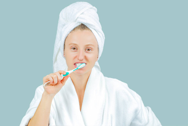 Facial care and beauty treatments. Beautiful woman brushing teeth - Fotoğraf, Görsel