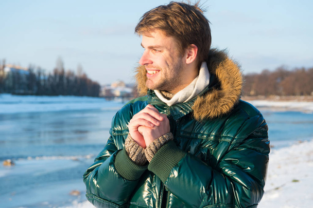 Happy winter holidays. Flu and cold. Winter fashion. Green warm coat. Warm clothes for cold season. Man traveling in winter, nature. Sexy man in warm clothes. Full of happiness. Winter time fun - 写真・画像