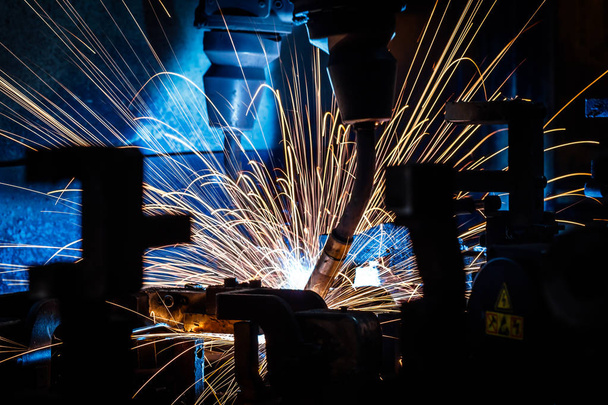 Welding robots movement in a car factory (manufacturing, industry, factory) - Photo, Image