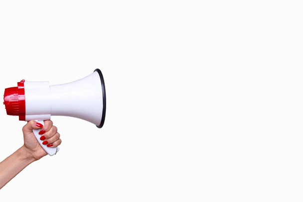 Woman holding a bullhorn or megaphone isolated on a white background with copy space in a conceptual image of vocal communication, protest or public speaking - Photo, Image