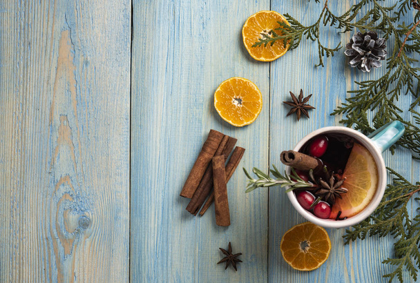 Red wine christmas blue background orange cinnamon top view  - Φωτογραφία, εικόνα
