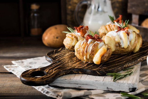 Appetizer of baked potatoes with bacon and fresh yogurt - Photo, Image