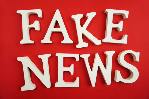 Fake News word alphabet letters on red background - Photo, Image