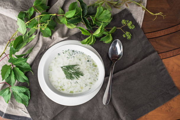 Vegetable cream soup with herbs in bowl on grey napkin - 写真・画像