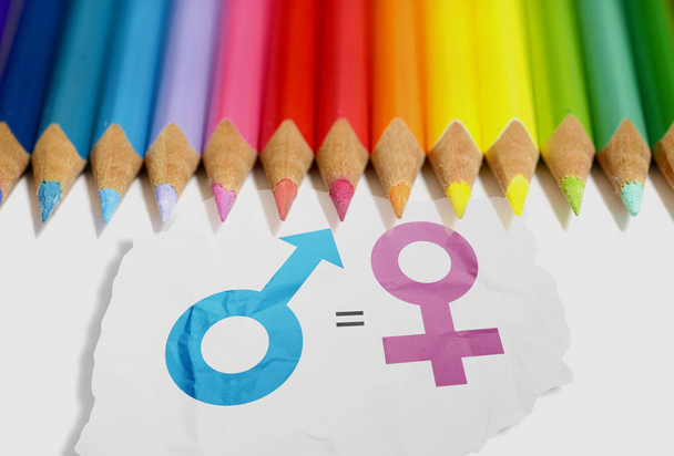Colored pencils with equality of gender symbol in the white paper. Equality gender concept - Foto, immagini