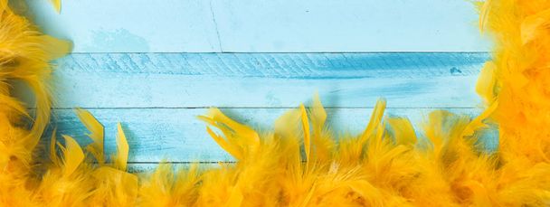 beautiful blue carnival background with yellow feathers - 写真・画像