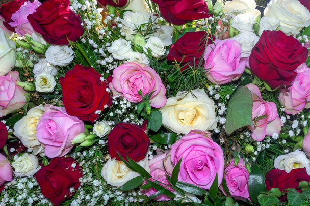 Beautiful flower arrangement of white, pink and red roses in closeup - Photo, Image