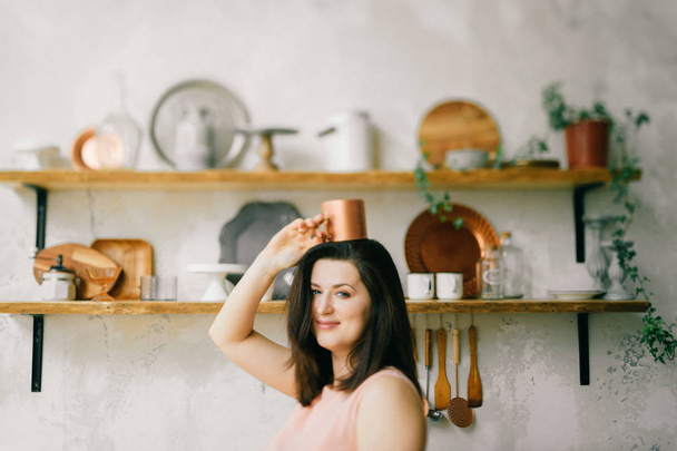 young beautiful woman in kitchen at home - Fotografie, Obrázek