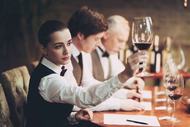 Group of sommeliers make wine card in restaurant. Tasting of elite alcoholic beverages. - Photo, image