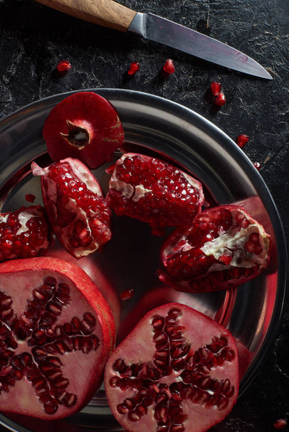 Top view of tasty pomegranates in metal bowl - Zdjęcie, obraz