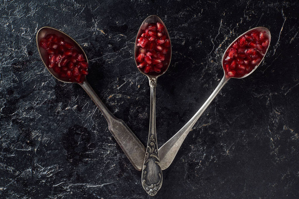 Flat lay with silverware and garnet seeds - Foto, immagini