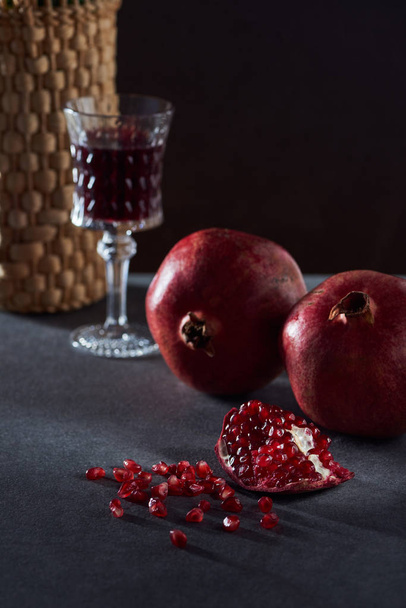 Studio shot of vintage wineglass and pomegranates - Photo, Image