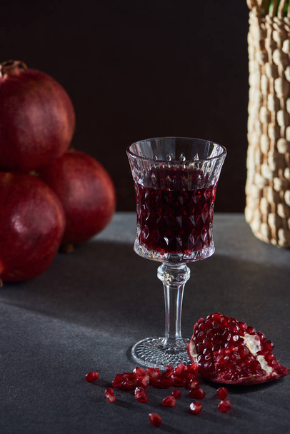 Studio shot of wineglass with wine and garnets - Foto, Imagem