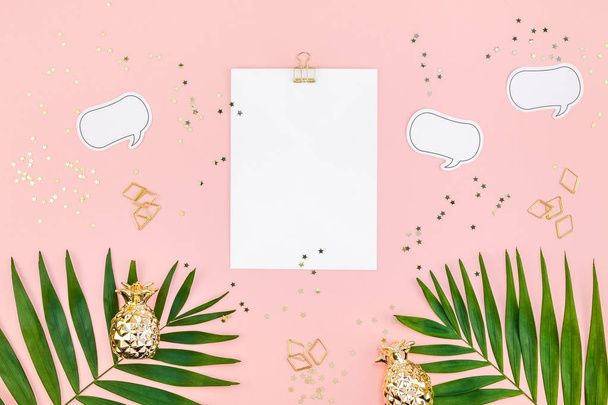 Creative flat lay top view mock up blank paper sheet postcard clip board green tropical palm leaves on millennial pink paper background copy space. Minimal tropical palm leaf plants summer concept - Foto, Bild