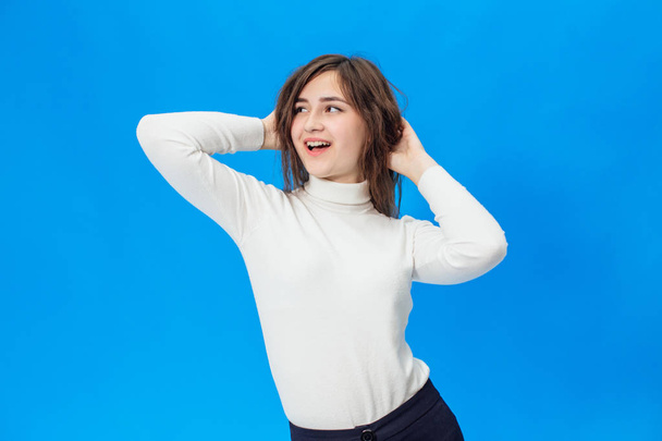 Young beautiful girl isolated on blue background - Foto, imagen