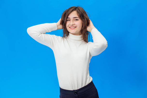 Young beautiful girl isolated on blue background - Фото, зображення