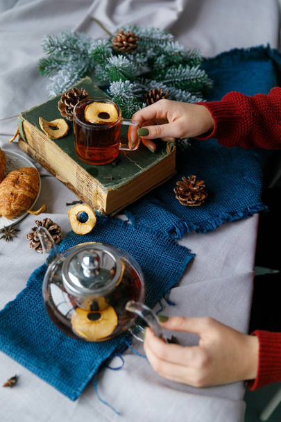 New Years table with fir branches and decorations on a wooden background. Christmas tea with cookies, gingerbread, small stars. - Фото, зображення