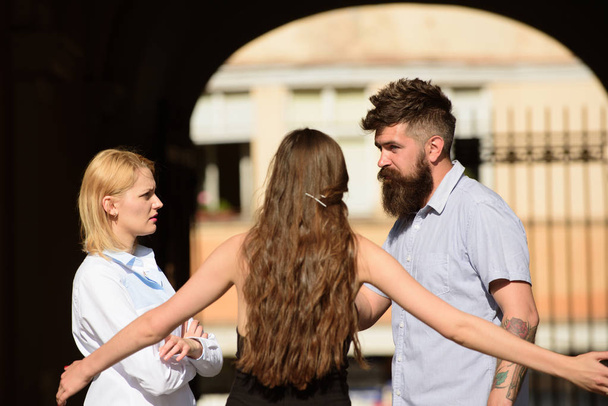 Mutual understanding and compassion. Friendship relations. Friends meeting on street. Bearded man and pretty women talking together. Boyfriend dating girlfriends. Bonds of friendship - Foto, afbeelding