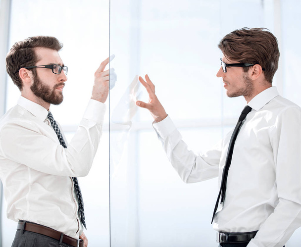 two businessmen on both sides of a glass Board - Photo, image