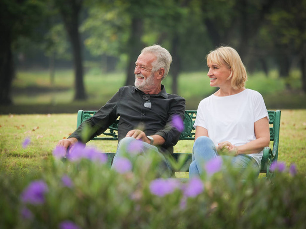 Two happy seniors retirement Man and woman are sitting and talking in park - Fotoğraf, Görsel