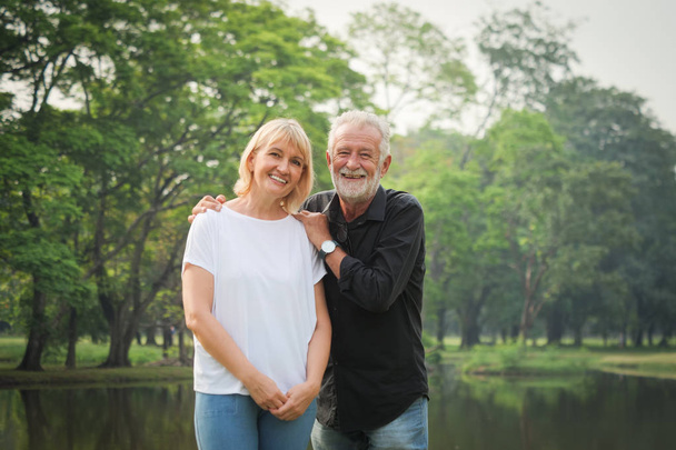 Portrait of Senior couple retirement Man and woman happy in park together - Photo, Image