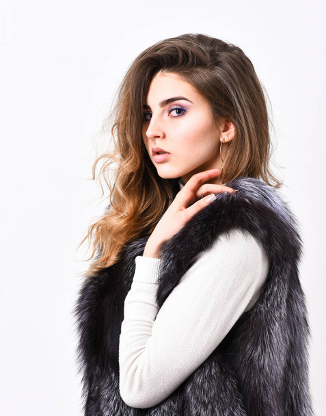 Silver fur vest fashionable clothing. Luxury furry accessory. Girl makeup face long hairstyle wear fur vest white background. Fashion trend winter clothes. Boutique luxury fur. Winter fashion concept - Photo, Image