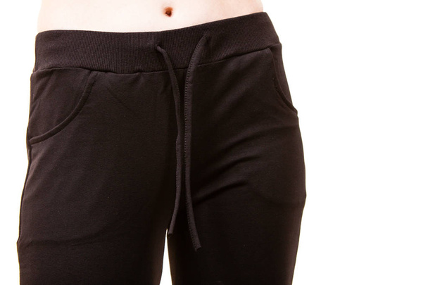 Close up woman wearing jumpsuit black trousers pants. Sporty outfit details concept. - Foto, immagini