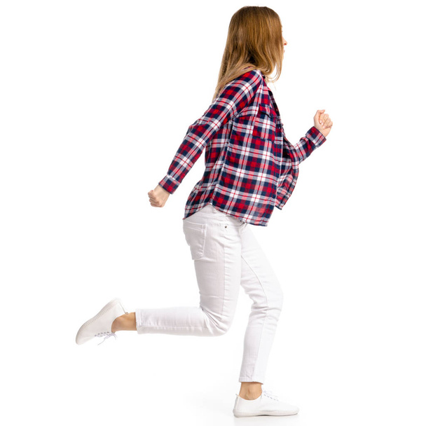Woman in white jeans and shirt run goes walking - Foto, immagini