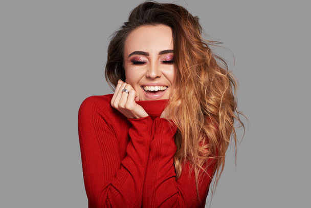 Glamour portrait of beautiful emotional girl model with bright makeup and romantic hairstyle. Holiday concept on Valentine day or 8 march. Woman have a fun and smiling on grey background - Foto, Imagem