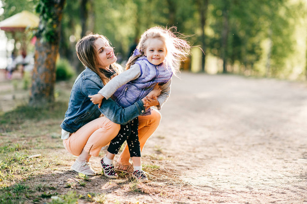 young happy mother and little daughter in park - Fotografie, Obrázek