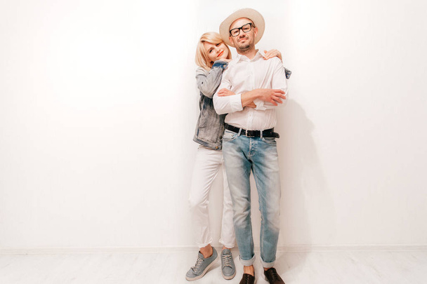 fashionable couple in trendy clothes standing at white wall at home - Foto, Bild