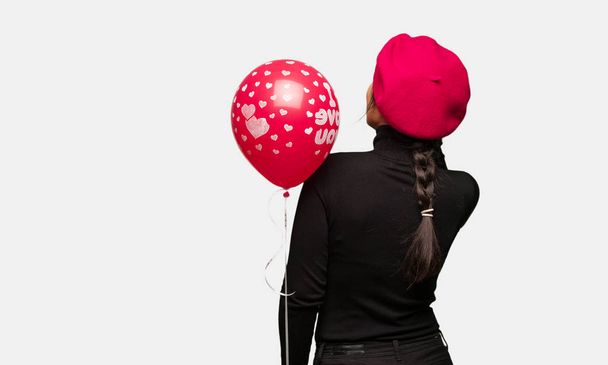 Young woman in valentines day from behind thinking about something - Photo, Image