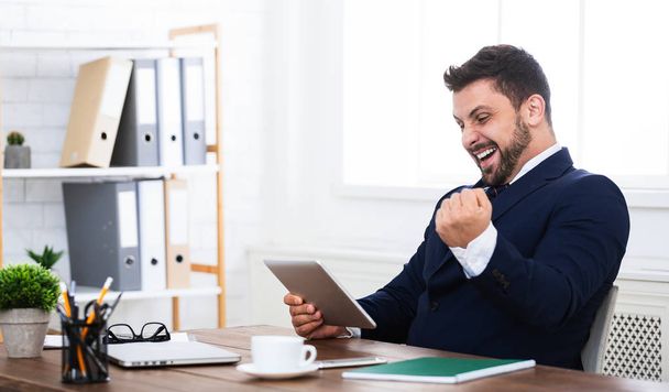 Hombre de negocios feliz con tableta digital, celebrando el éxito
 - Foto, Imagen
