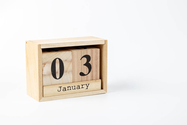 Wooden calendar January 03 on a white background close up - Фото, изображение