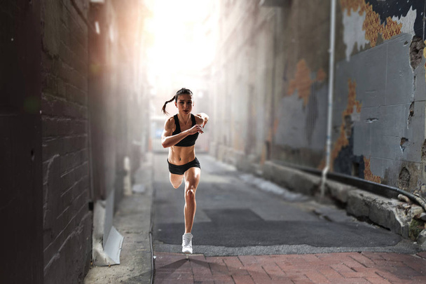 Sportswoman running race. Mixed media - Valokuva, kuva