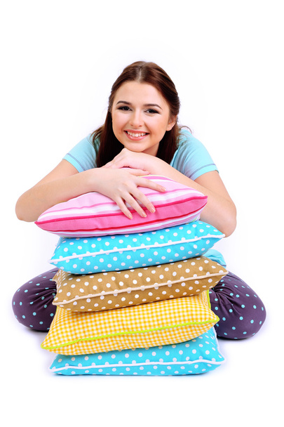 Beautiful young girl with pillows isolated on whit - Fotografie, Obrázek