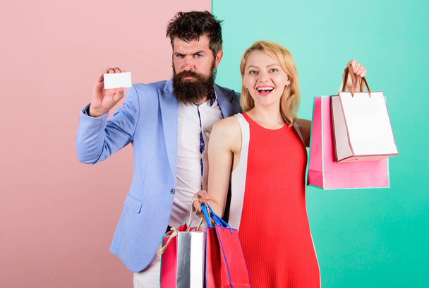 Couple with luxury bags in shopping mall. Couple enjoy shopping. Man bearded hipster hold credit card and girl enjoy shopping. Ask man to purchase lots presents for girlfriend. Paying while dating - Fotografie, Obrázek