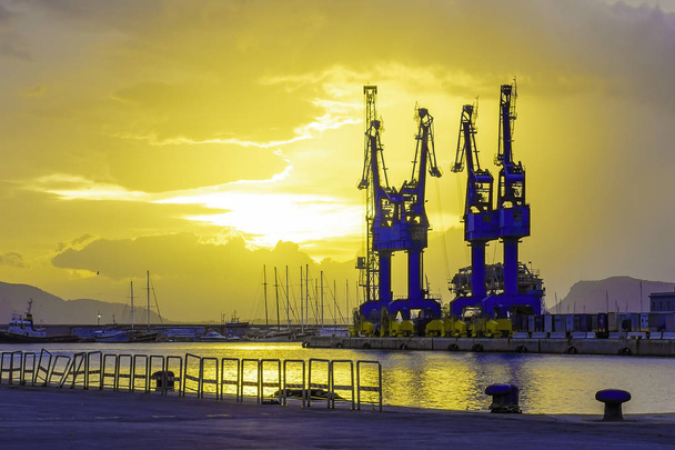 Big port cargo cranes in Palermo, Italy in a beautiful summer sunrise - Photo, Image