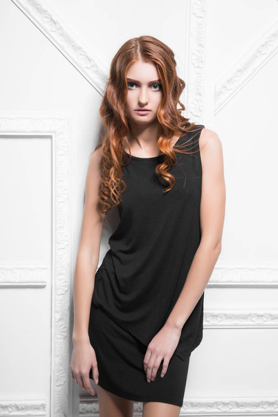 beautiful woman in black dress posing in studio - Fotografie, Obrázek
