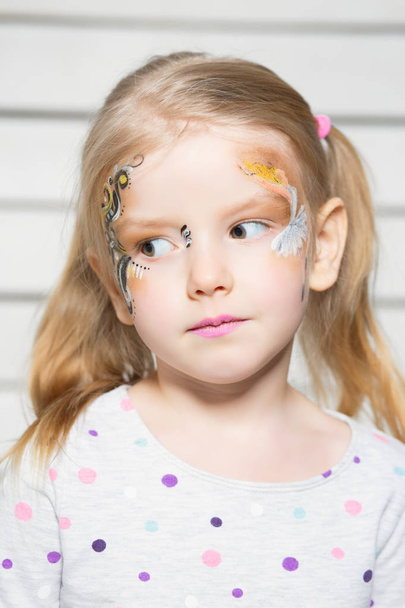 portrait of little girl with colorful face - Φωτογραφία, εικόνα