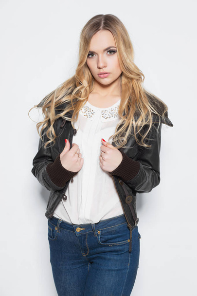 Portrait of young blonde woman in stylish clothing posing against white background - Photo, Image