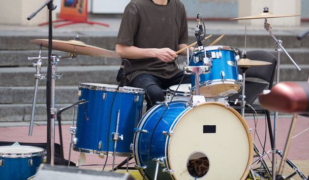 young drummer playing on city street - Photo, Image