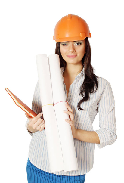The woman in the construction helmet with working drawing - Foto, Bild