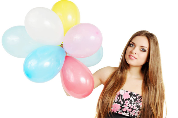 Young woman holding a bunch of balloons - Фото, изображение