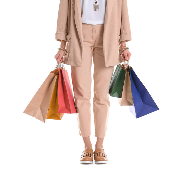 Young woman with shopping bags on white background, closeup - Foto, Bild