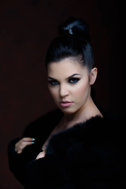 Portrait of a pretty girl with a black fur  - Fotografie, Obrázek