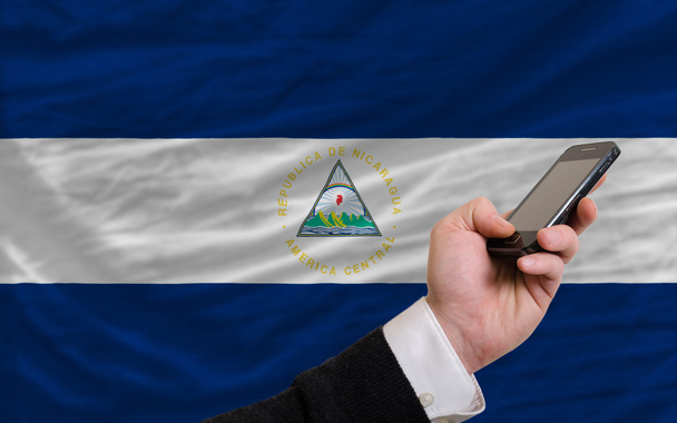 cell phone in front national flag of nicaragua - Photo, Image