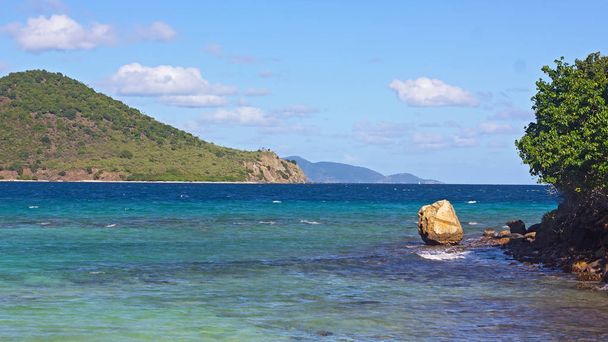 Tropical island landscape with sea view and several mountainous islands on horizon, St. Thomas, Virgin Islands US. Gentle waves and rocky shoreline of the island. - Fotó, kép
