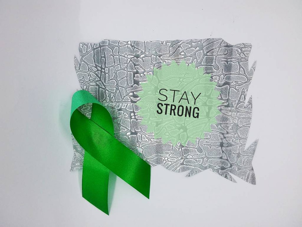 ruban de sensibilisation au cancer avec des mots "rester fort" sur fond blanc
. - Photo, image